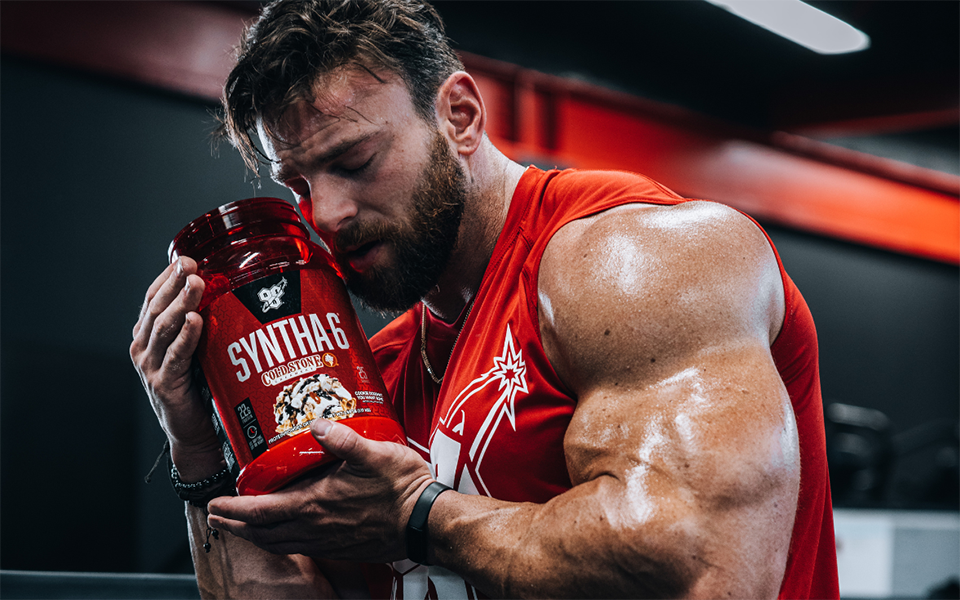 man holding bsn shaker while sitting on steps