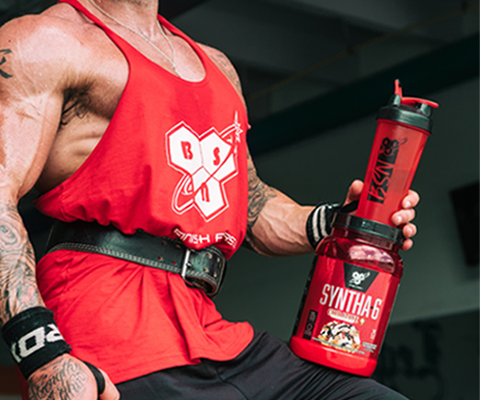 man holding bsn shaker and syntha-6